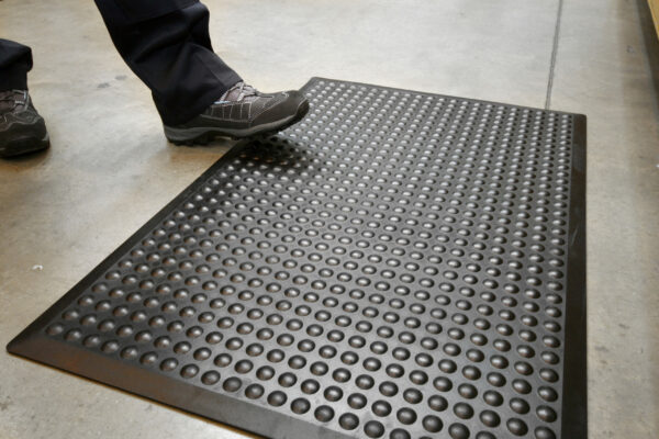 Person stepping on a black Bubbled Detailed Mat