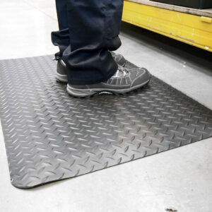 Person standing on a black Diamond Detailing Mat