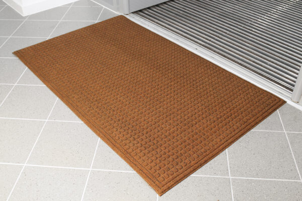 Brown eco-doormat beside an entrance