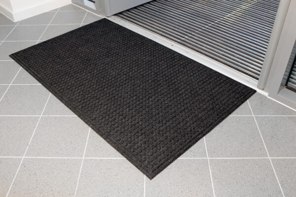Black Eco-Doormat inside a door entrance