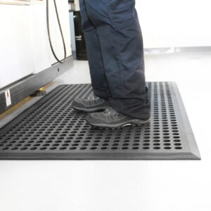 Person standing on a black Worksafe mat at workstation